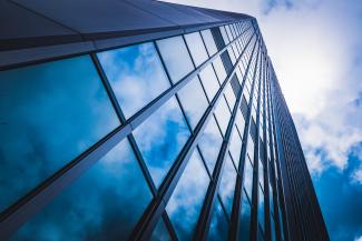 Glass building with clouds